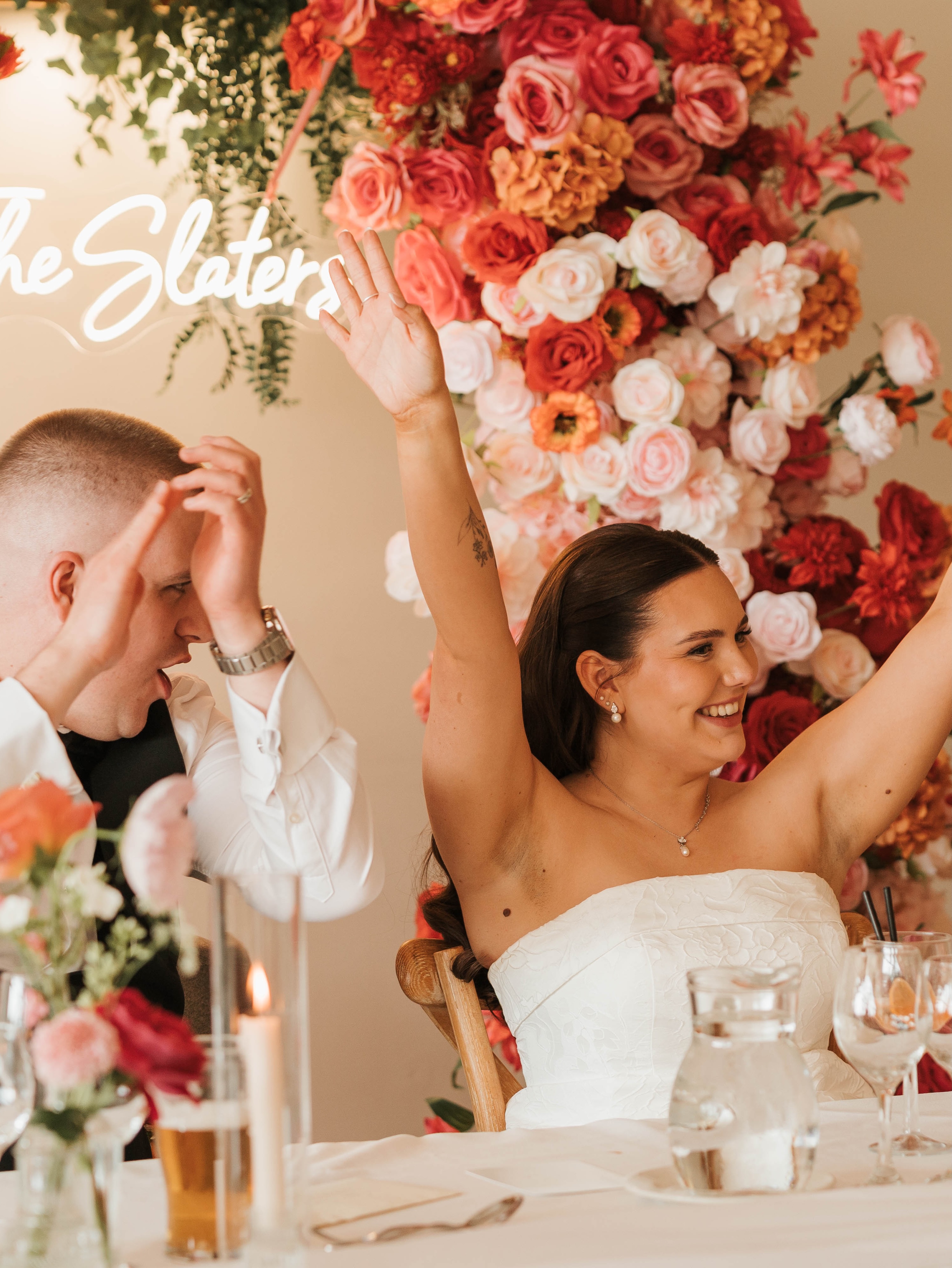 🌸 Before and after the big entrance… a backdrop to memories that’ll last forever 🧡
.
Perfectly captured by @photographybyamielouise
.
#floralarch #flowerpillars #sweethearttable #weddingflowerinspo #pinkandorange