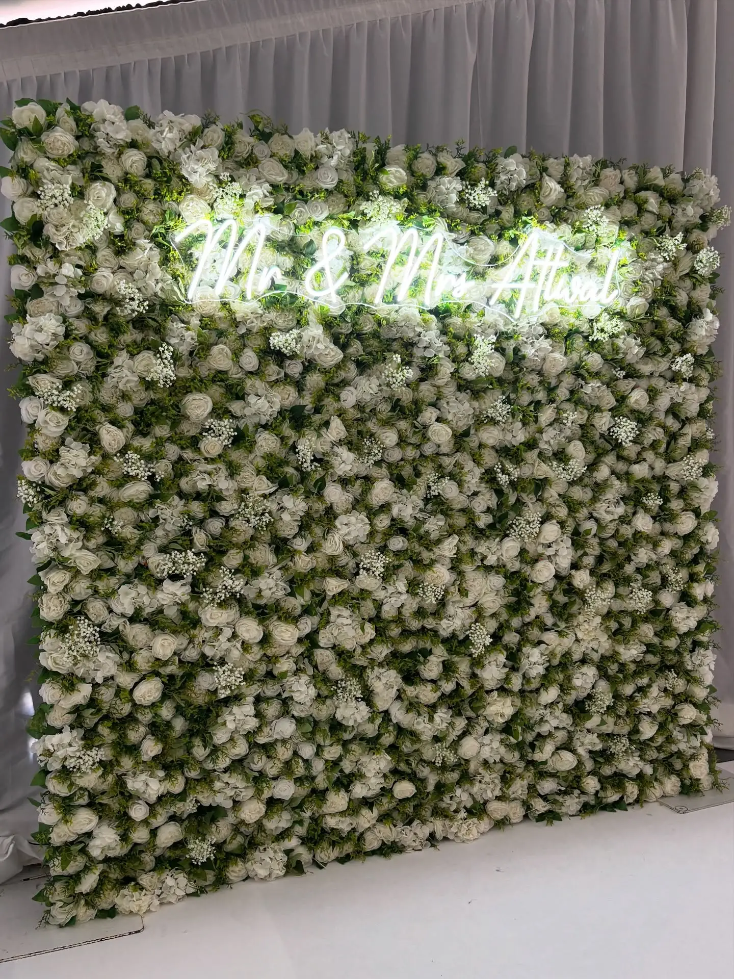A touch of timeless elegance for the beautiful Mr & Mrs Attwal 💍🌿 We were honoured to be part of this special day with our signature ‘Marilyn’ flower wall – a lush, romantic blend of rich green foliage and crisp white blooms, with added Gypsophila, designed to complement any modern love story 🤍
.
The cool white neon sign added the perfect glow, making this backdrop a true statement piece for the celebration. Classic sophistication with a modern twist ✨
.
#FlowerWall #WeddingDecor #NeonSign #LuxuryWeddingBackdrop #NeonVibes #FlowerWallGoals #UKWeddingSupplier #FoliageWall #WhiteWedding #WeddingStyle #WeddingAesthetic #MidlandsWeddings #EventStyling #WeddingInspo #Gypsophila #ModernRomance #GreeneryWall #FloralWall