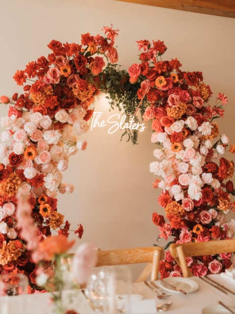 ‘Juliet’ Flower Arch - the most romantic backdrop to frame a sweetheart table 😍 This time with orange florals added to match Maya and Harry’s gorgeous colour palette @hanburybarnsvenue 🧡🌸
.
Incredible photography by @photographybyamielouise
.
#flowerarch #weddingflowers #floralbackdrop #sweethearttable #artificialflowers