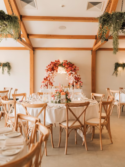 🌸 Before and after the big entrance… a backdrop to memories that’ll last forever 🧡
.
Perfectly captured by @photographybyamielouise
.
#floralarch #flowerpillars #sweethearttable #weddingflowerinspo #pinkandorange