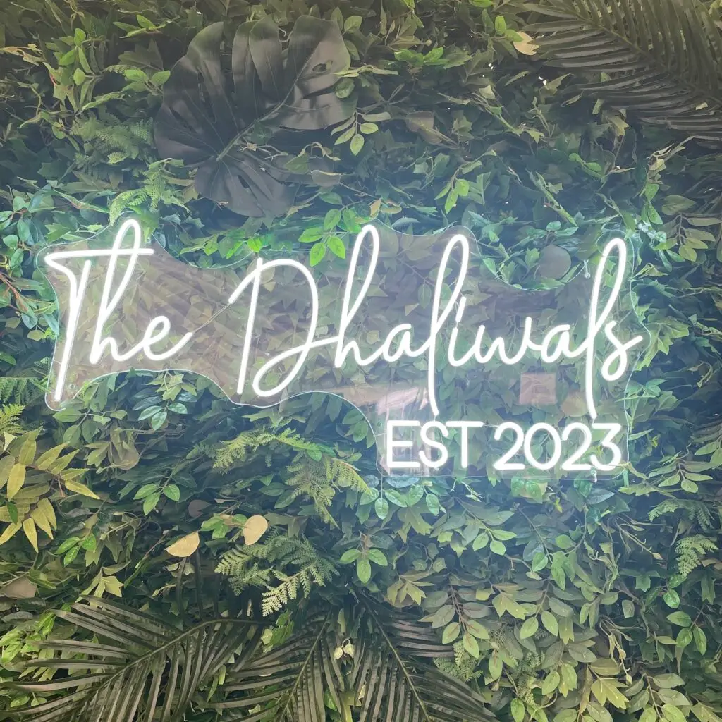 flower wall with neon sign