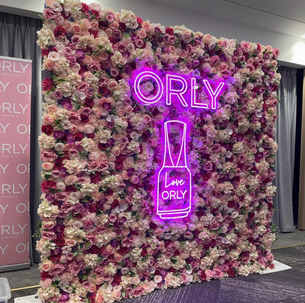 flower wall with neon sign